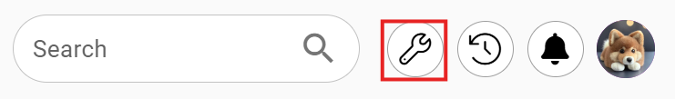 From left to right: a search bar, a wrench icon highlighted in red, a magnifying glass, a refresh symbol, a bell, and a user profile image.