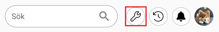 From left to right: a search bar, a wrench icon highlighted in red, a magnifying glass, a refresh symbol, a bell, and a user profile image.